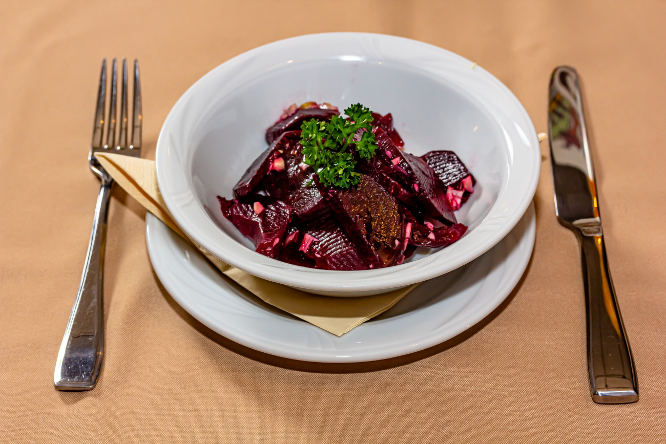 Baked beetroot salad with garlic is on the plate.