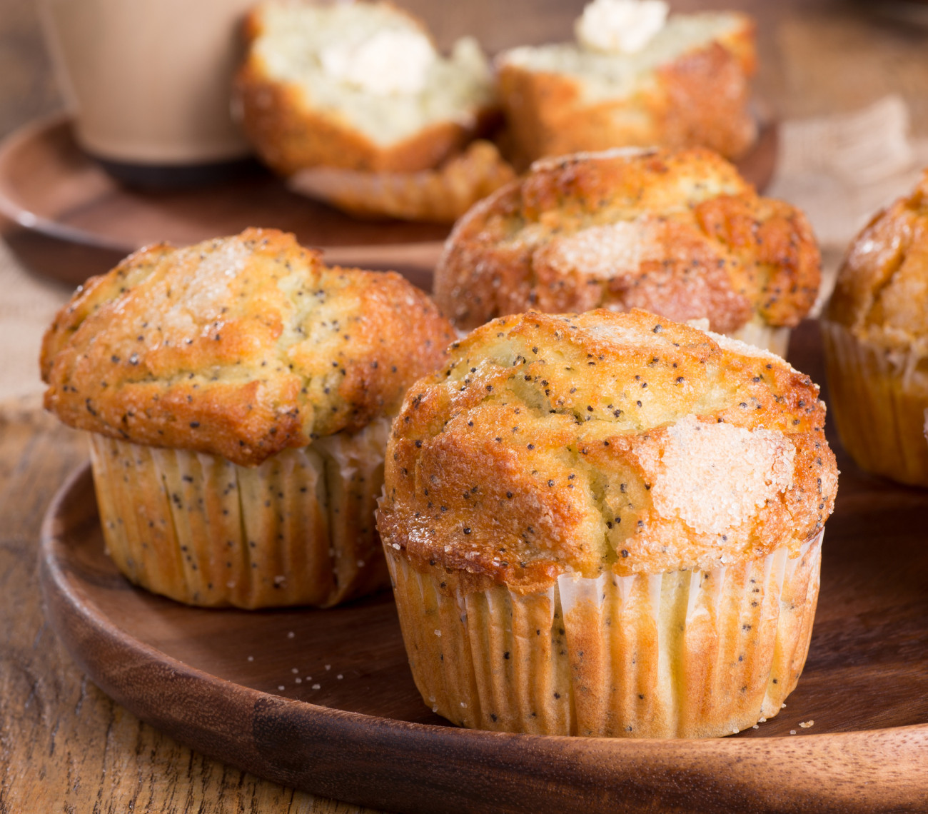 Closeup of lemon poppy seed muffins on a wooden plate