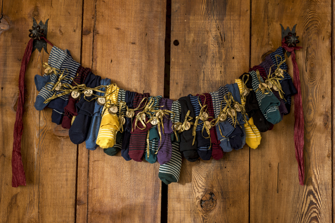 Lovely colorful handmade Sock Advent Calendar on redwood boards.